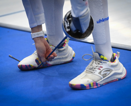 AZZA fencing shoe being laced before competition